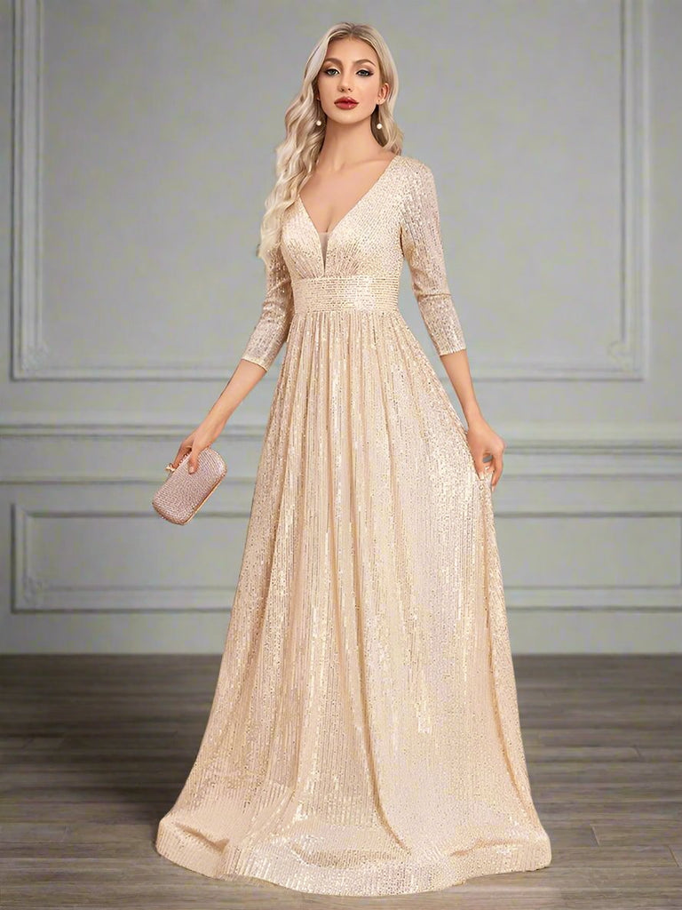 An elegant Champagne sequin gown with a deep V-neckline, 3/4 sleeves, and a flowing A-line silhouette is perfect for evening galas or formal occasions.