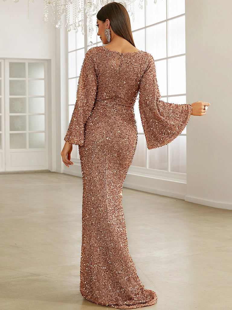 This stunning Pink sequin gown features a sweetheart neckline, dramatic bell sleeves, and a form-fitting mermaid silhouette, perfect for a glamorous evening event.