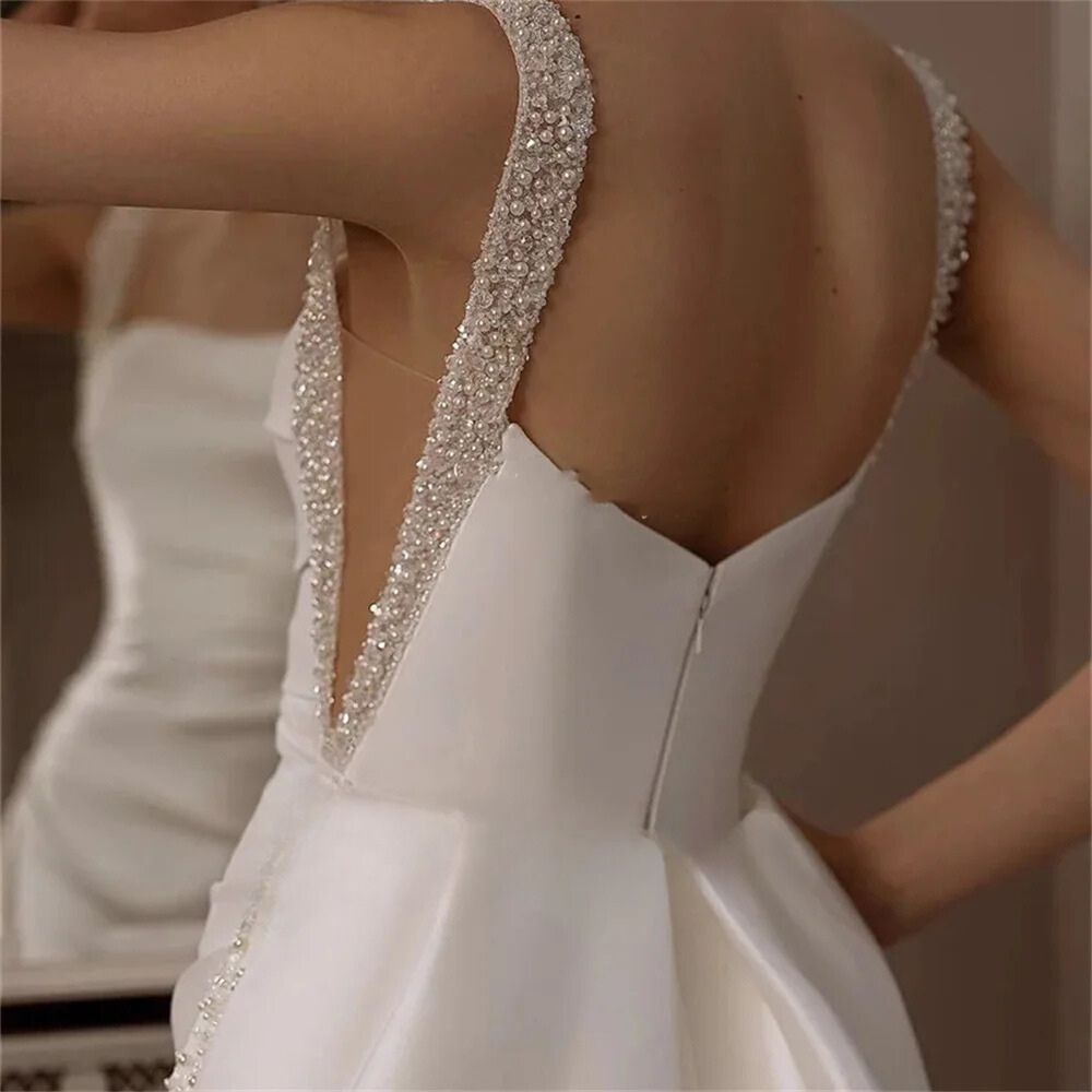 Spaghetti strap backless mermaid wedding dress with sequin beads, available in ivory and white.