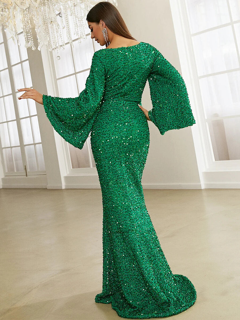 This stunning emerald green sequin gown features a sweetheart neckline, dramatic bell sleeves, and a form-fitting mermaid silhouette, perfect for a glamorous evening event.