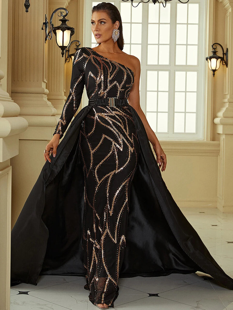 An Elegant black one-shoulder gown featuring intricate sequin detailing, a gold belt accent, and a dramatic cape for a regal and sophisticated look.