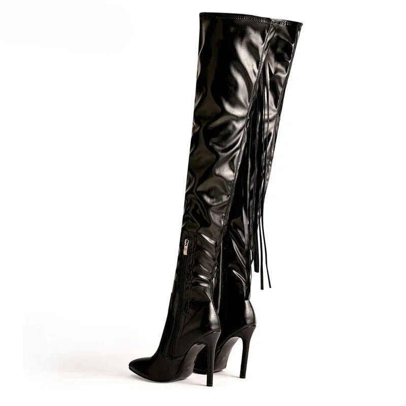 Black over-the-knee boots with pointed toes, high heels, and fringe details for a bold and fashionable winter style.