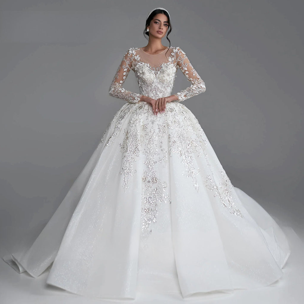 Exquisite long sleeve ball gown wedding dress with sequined beading and royal train, available in champagne, white, beige, ivory, and pink.