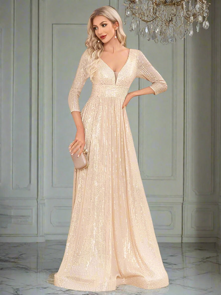 An elegant Champagne sequin gown with a deep V-neckline, 3/4 sleeves, and a flowing A-line silhouette is perfect for evening galas or formal occasions.