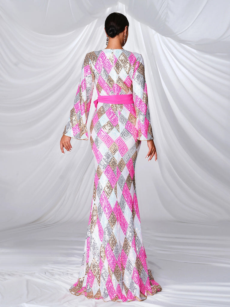 kaftan-style gown adorned with pink and gold geometric patterns, featuring wide bell sleeves, a front slit, and a bold pink sash accentuating the waist for a sophisticated and luxurious look.