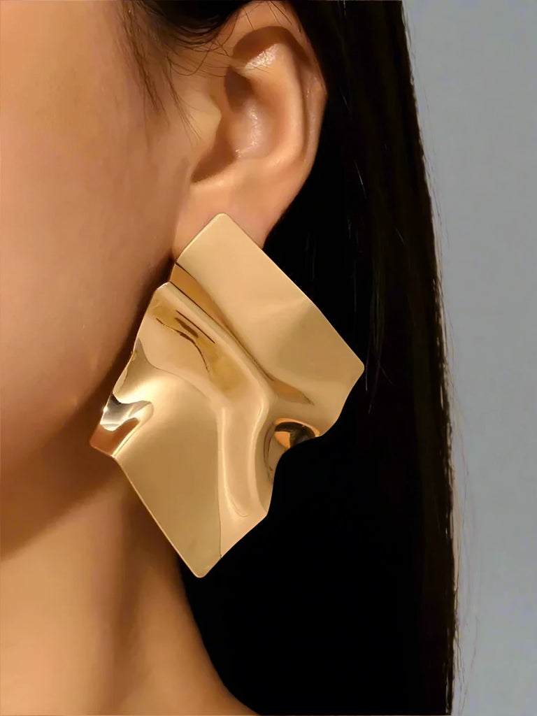 Modern gold-tone earrings with an abstract, flowing design, featuring smooth, sculptural curves that create a bold and artistic statement.







