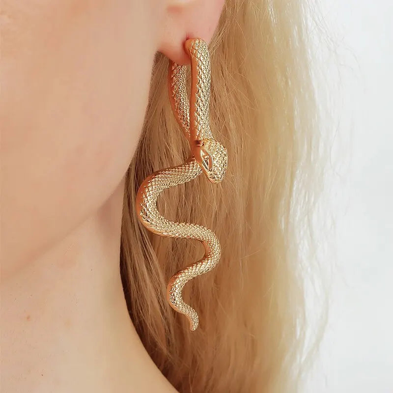 elegant snake-shaped earrings in a gold-tone finish, featuring intricate scale detailing and a lifelike, coiled design that adds a touch of bold sophistication to any outfit.