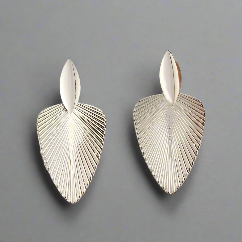 Elegant Silver-tone earrings featuring a textured leaf design, combining modern sophistication with a nature-inspired motif, perfect for adding a stylish touch to any outfit.