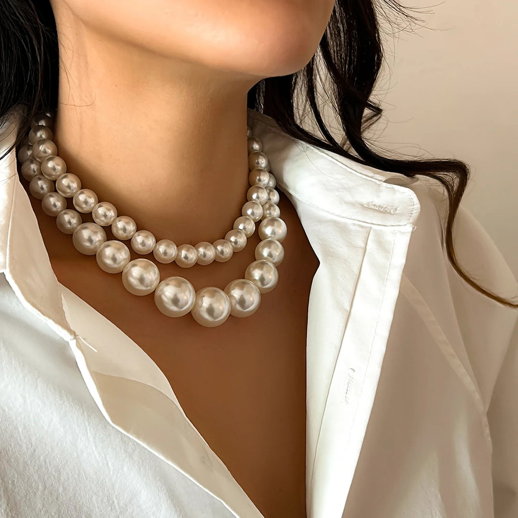 A luxurious double-strand pearl necklace featuring large, lustrous pearls in a graduated design, adding a touch of timeless elegance and sophistication to any outfit.