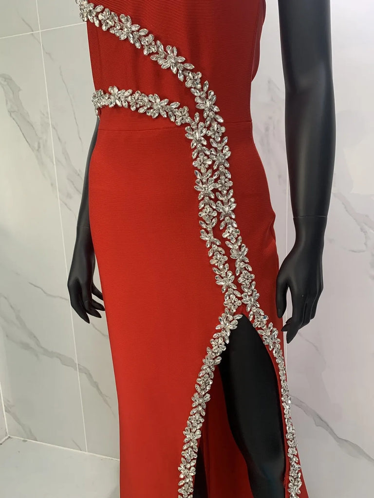 Halter red prom dress with sparkling crystals, sleeveless design, and a dramatic side split, perfect for formal occasions.