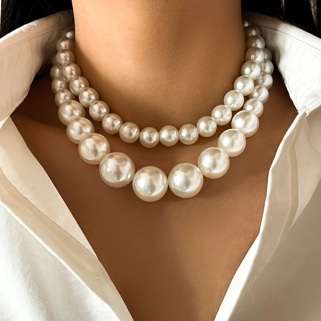 A luxurious double-strand pearl necklace featuring large, lustrous pearls in a graduated design, adding a touch of timeless elegance and sophistication to any outfit.