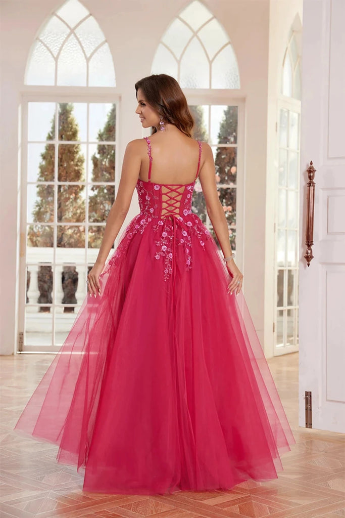 An elegant pink  tulle ball gown features a fitted bodice adorned with delicate floral appliqués and thin straps. The full, flowing skirt adds a fairytale touch, perfect for proms, formal events, or weddings.