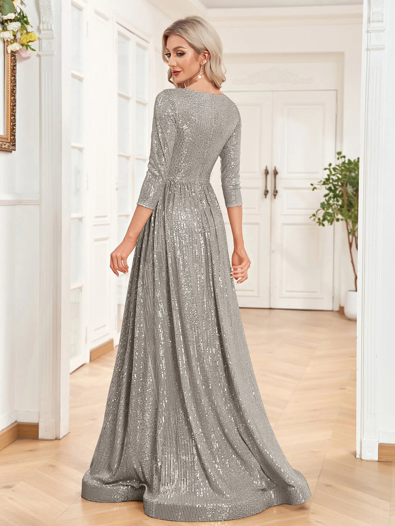 An elegant Silver sequin gown with a deep V-neckline, 3/4 sleeves, and a flowing A-line silhouette is perfect for evening galas or formal occasions.