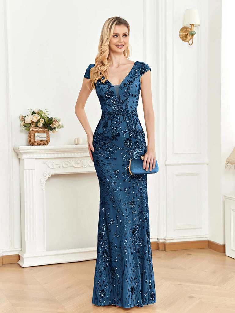 blue evening gown with cap sleeves, embellished with intricate floral appliqués and sequin detailing. This fitted dress features a deep V-neckline and a subtle flare at the bottom, creating a graceful silhouette that is perfect for formal events.