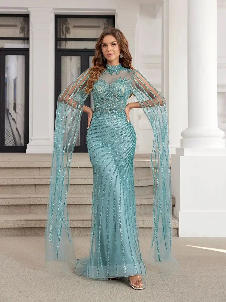 Beaded mint mermaid evening dress with a cape, perfect for prom and formal events.