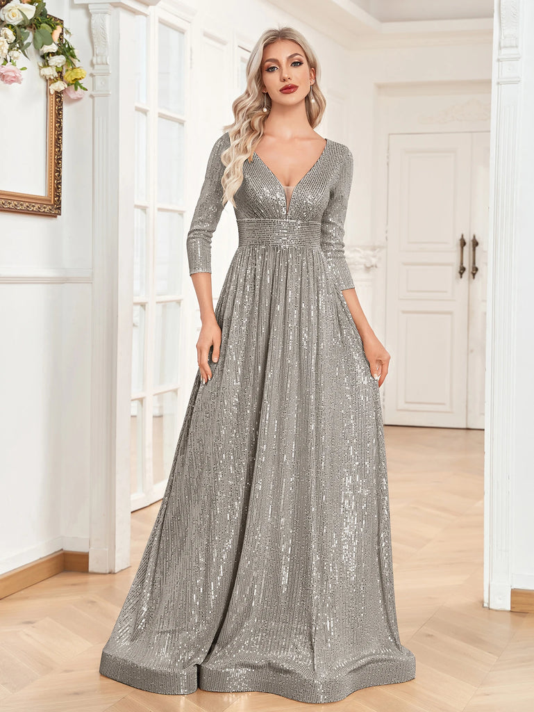 An elegant Silver sequin gown with a deep V-neckline, 3/4 sleeves, and a flowing A-line silhouette is perfect for evening galas or formal occasions.