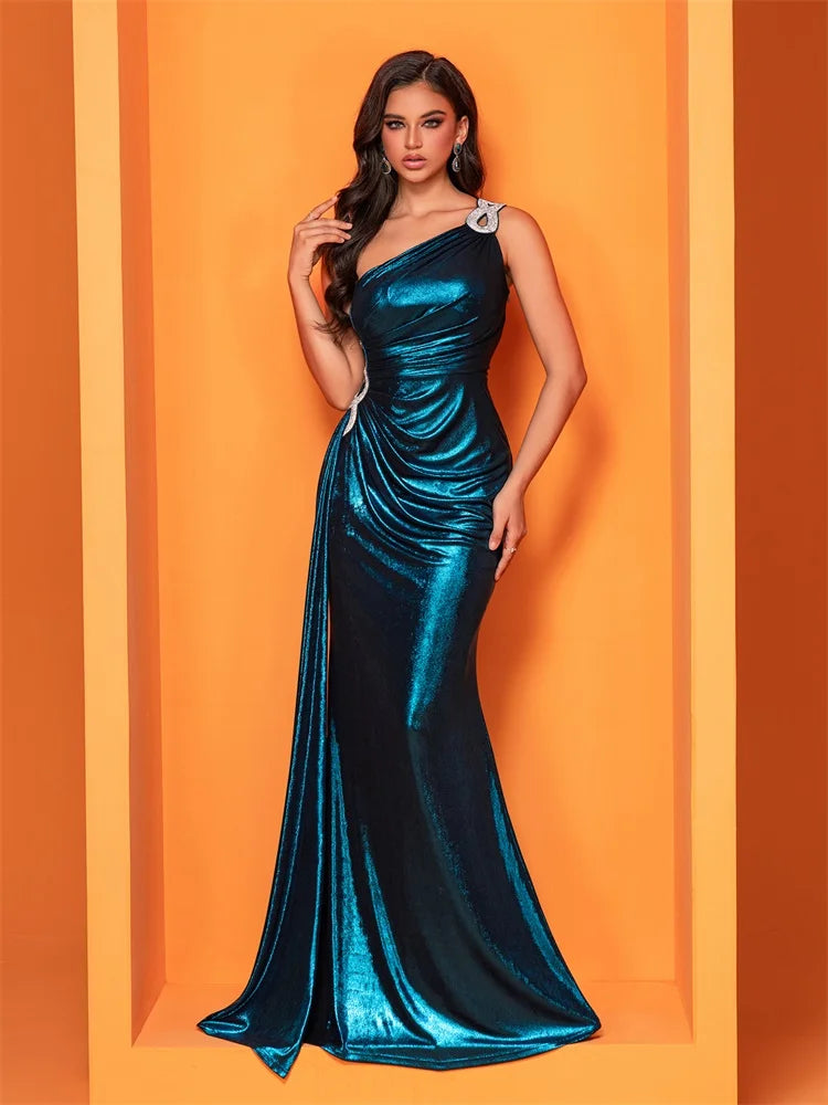 Radiant teal one-shoulder gown featuring shimmering fabric, intricate side embellishments, and a ruched design for an elegant and flattering silhouette..