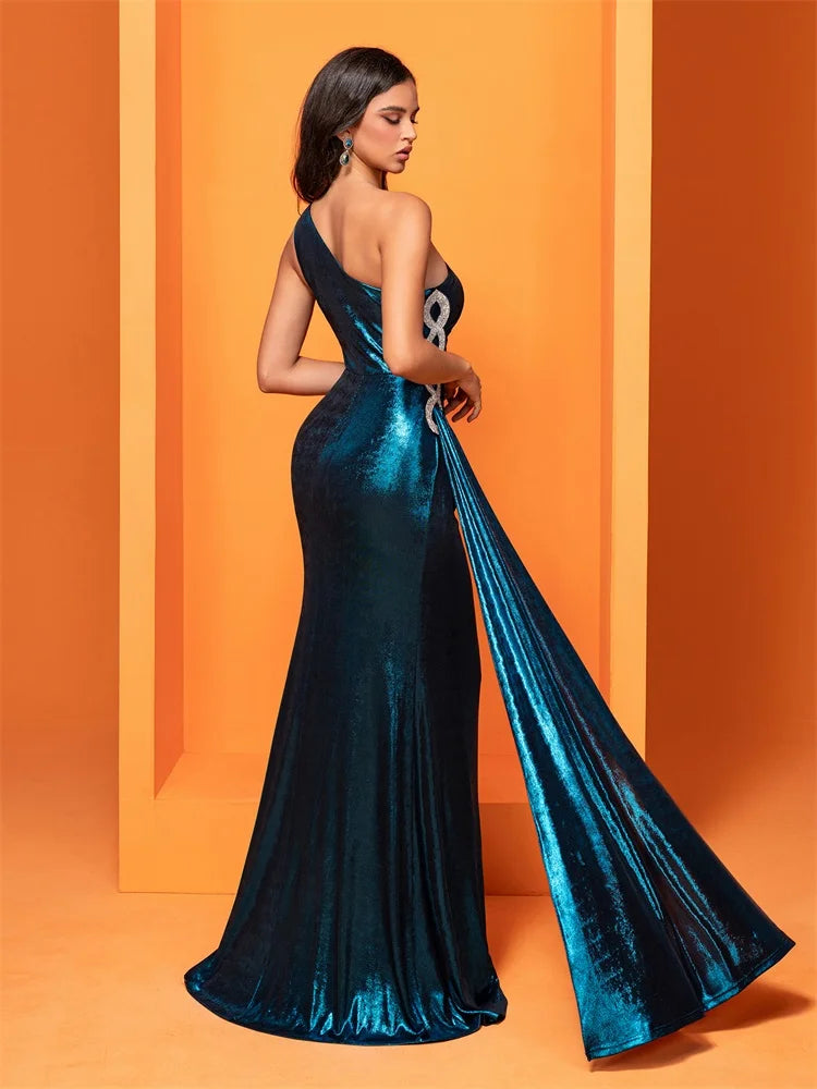 Radiant teal one-shoulder gown featuring shimmering fabric, intricate side embellishments, and a ruched design for an elegant and flattering silhouette.