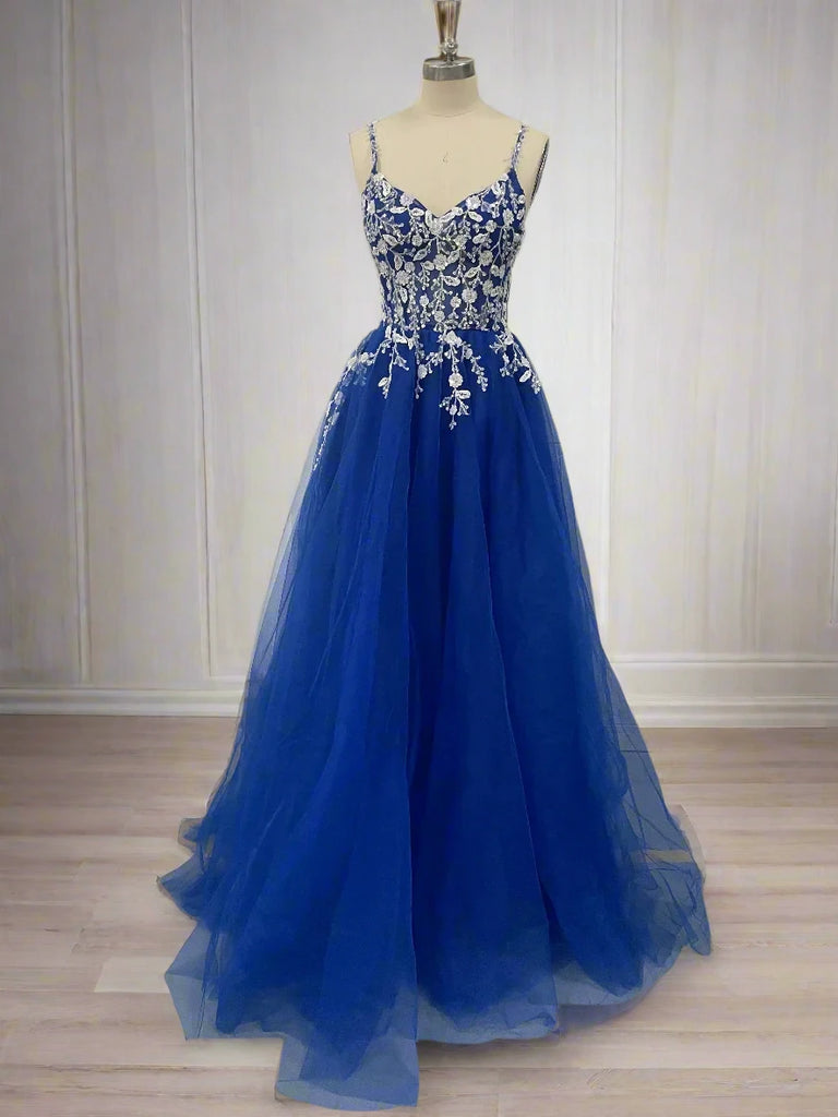 An elegant blue tulle ball gown features a fitted bodice adorned with delicate floral appliqués and thin straps. The full, flowing skirt adds a fairytale touch, perfect for proms, formal events, or weddings.