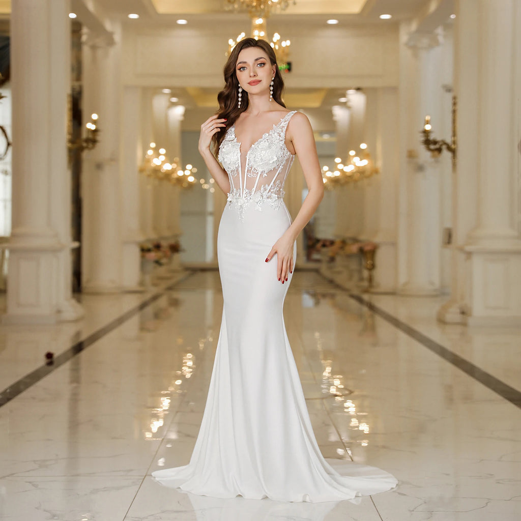 Elegant straps white mermaid wedding dress with lace pearls and backless V-neck design.