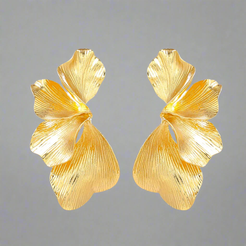 A pair of Gold delicate floral leaf stud earrings, intricately designed with a nature-inspired motif, perfect for adding a touch of elegance and charm to any outfit.
