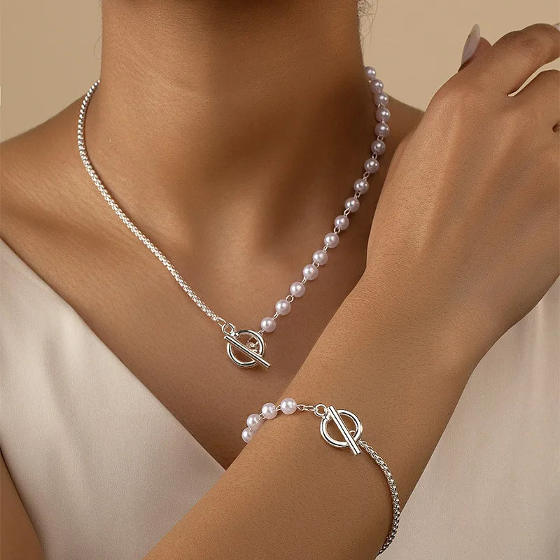 stylish jewelry set featuring a necklace and bracelet, combining classic pearls with a modern Silver-tone chain and toggle clasp, offering a chic and elegant accessory perfect for any occasion.