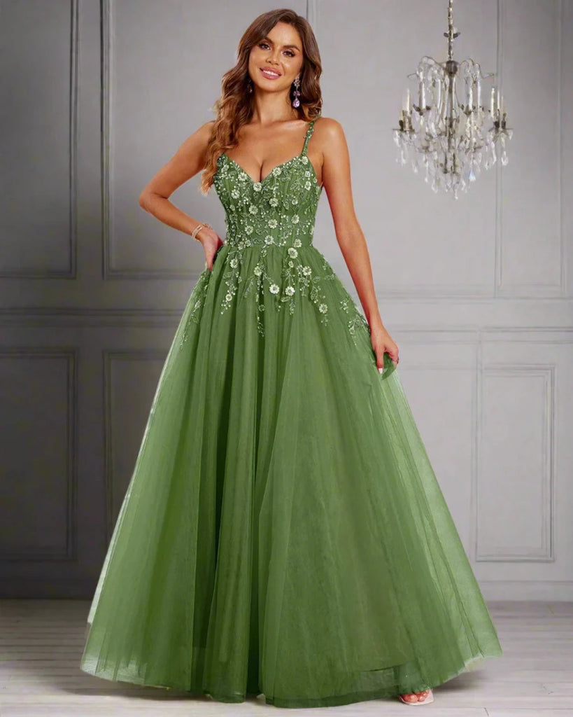 An elegant pastel green tulle ball gown features a fitted bodice adorned with delicate floral appliqués and thin straps. The full, flowing skirt adds a fairytale touch, making it perfect for proms, formal events, or weddings.