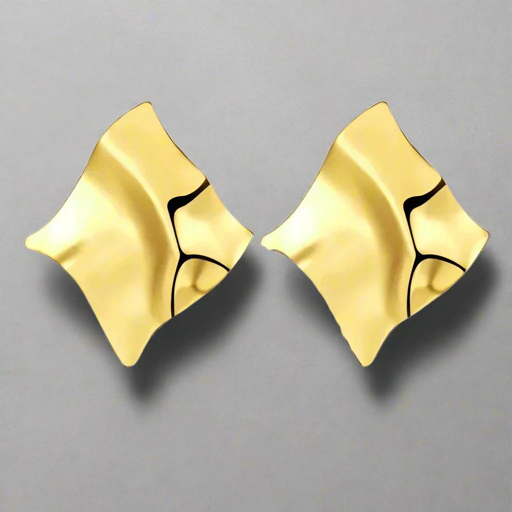 Modern gold-tone earrings with an abstract, flowing design, featuring smooth, sculptural curves that create a bold and artistic statement.







