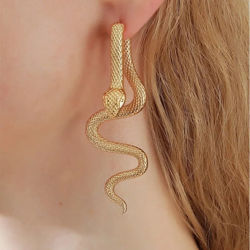 elegant snake-shaped earrings in a gold-tone finish, featuring intricate scale detailing and a lifelike, coiled design that adds a touch of bold sophistication to any outfit.