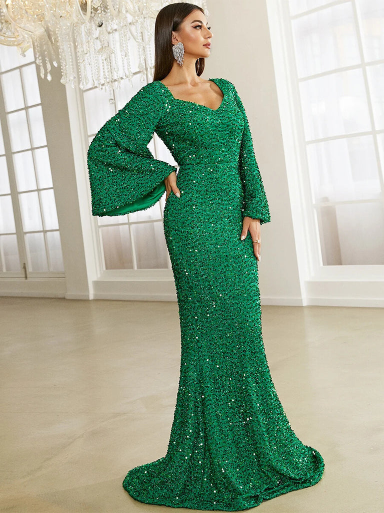 This stunning emerald green sequin gown features a sweetheart neckline, dramatic bell sleeves, and a form-fitting mermaid silhouette, perfect for a glamorous evening event.